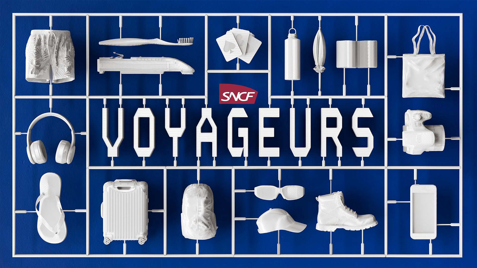 SNCF Voyageurs wordmark shown in white letters surrounded by white minimal items laid out precisely including clothing, footwear and electronics