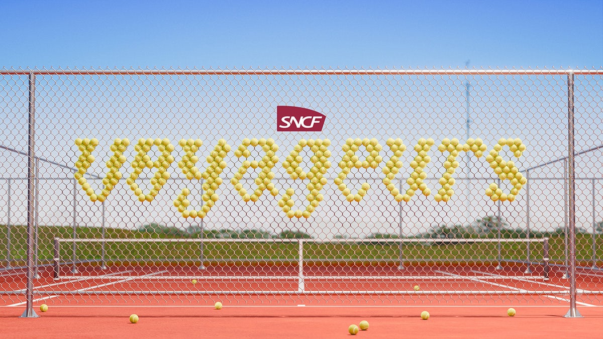 SNCF Voyageurs wordmark shown in the style of tennis balls stuck in the wiring of a tennis court fence