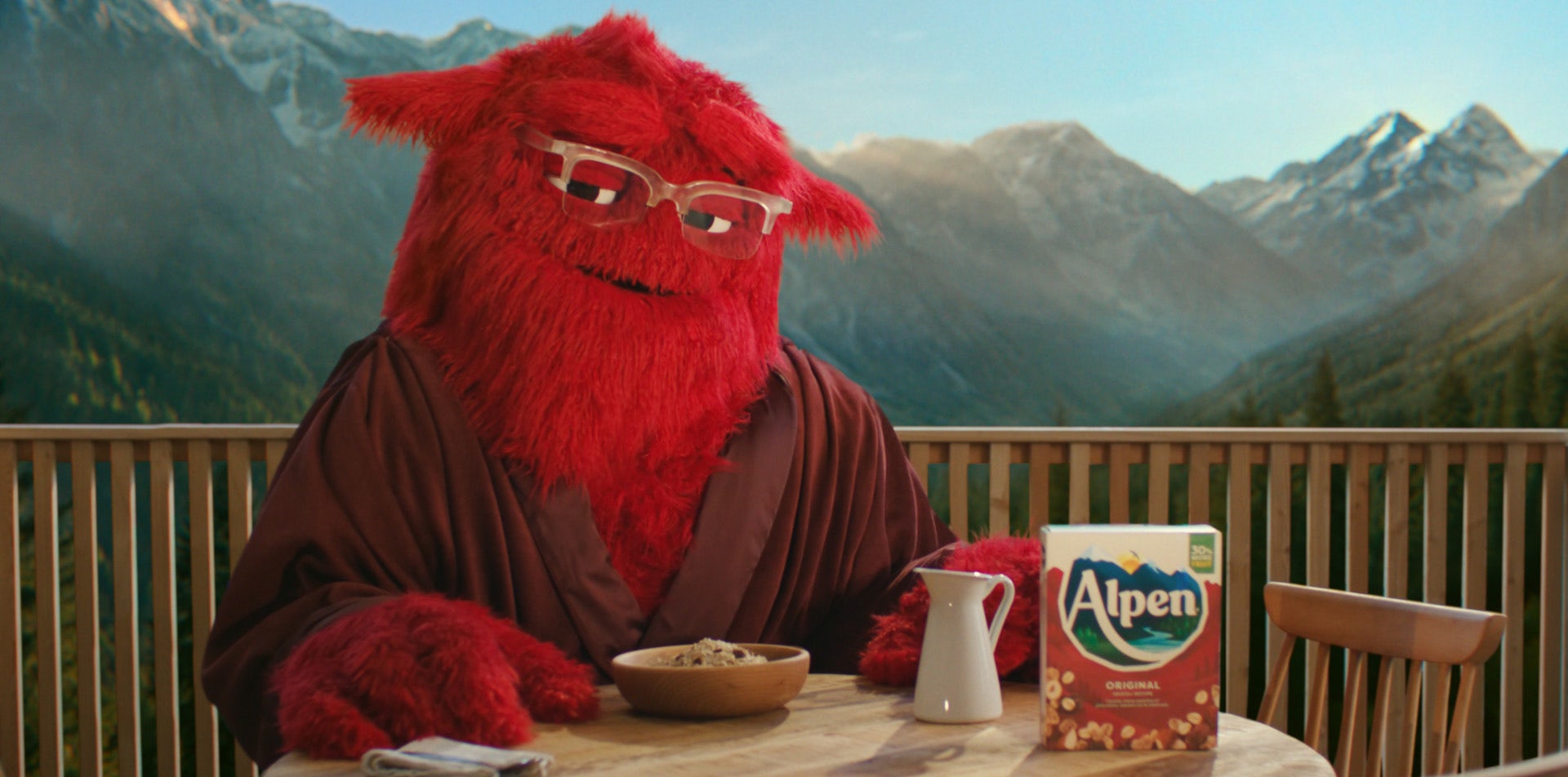 Still for an Alpen ad showing a red fuzzy character in a dressing gown with a bowl of muesli