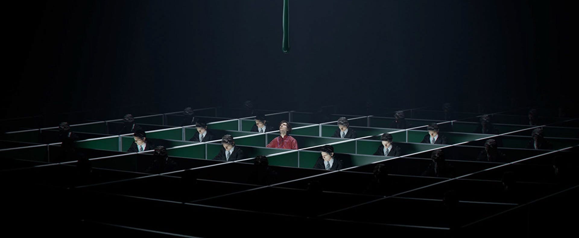 Still from the Severance season one title sequence by Extraweg showing a 3D visualisation of the character Mark sat at a desk in a darkened room filled with conjoined desks