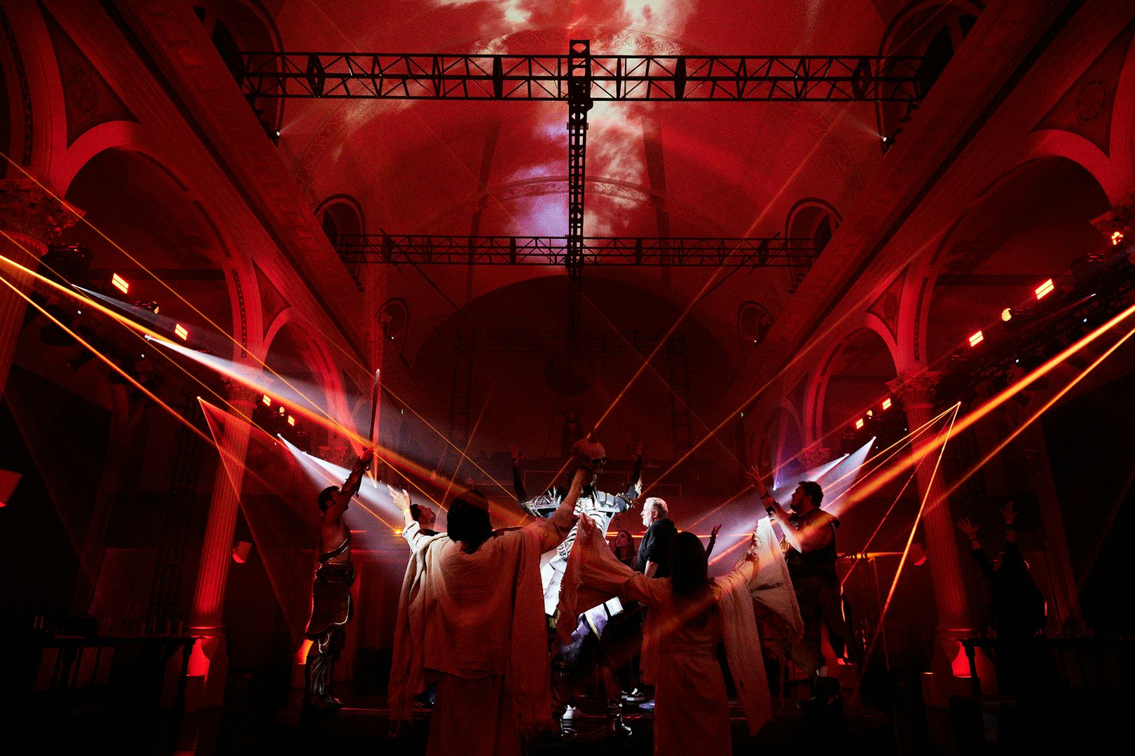 A crowd in a red hued hall at the Diablo IV event by Studio Secret Cinema