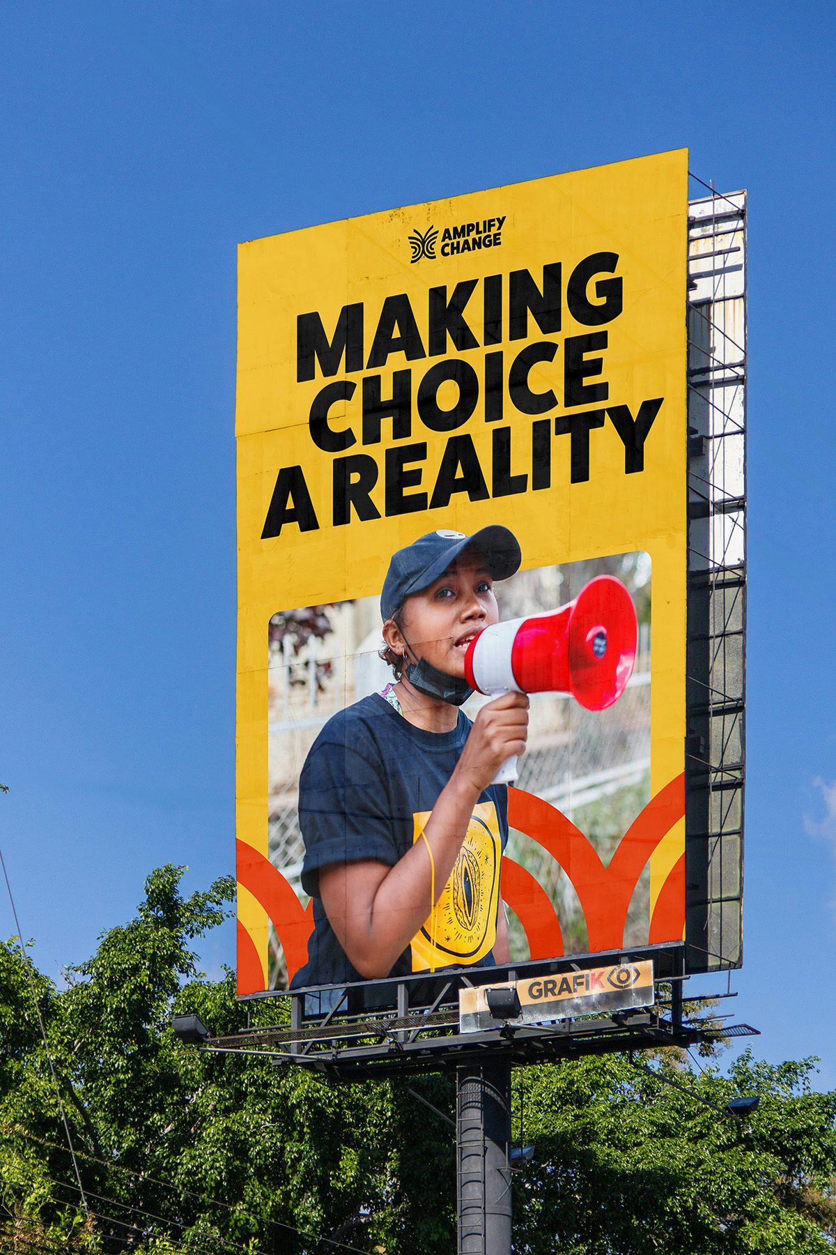 Billboard headlined 'making choice a reality' and a photo of a person speaking into a megaphone
