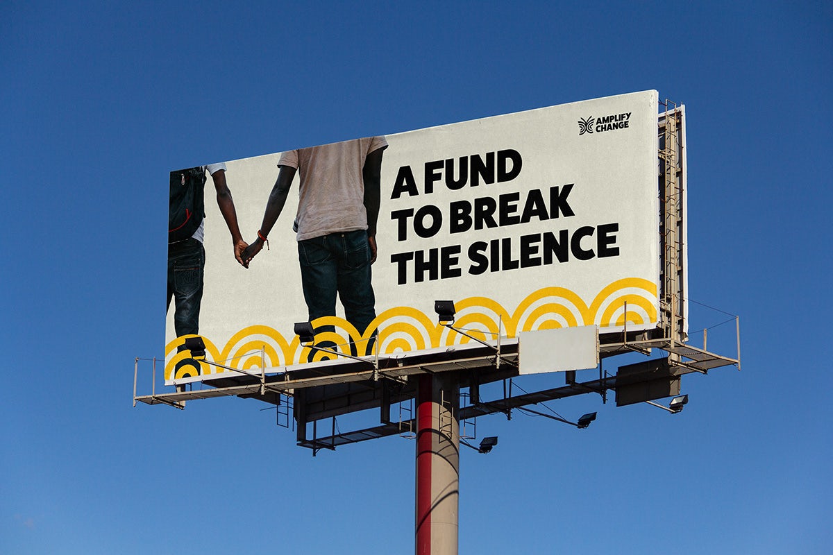 Billboard headlined 'a fund to break the silence' and a photo of people holding hands