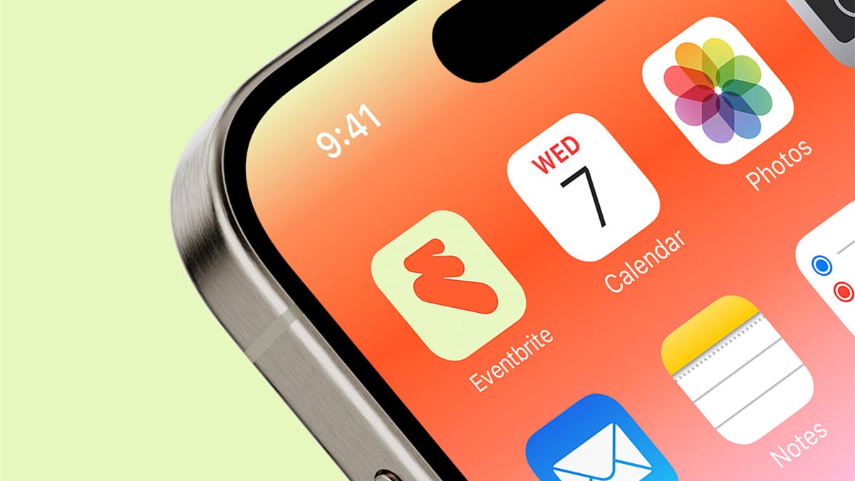 Smartphone showing the Eventbrite app icon of an orange curving 'E' symbol