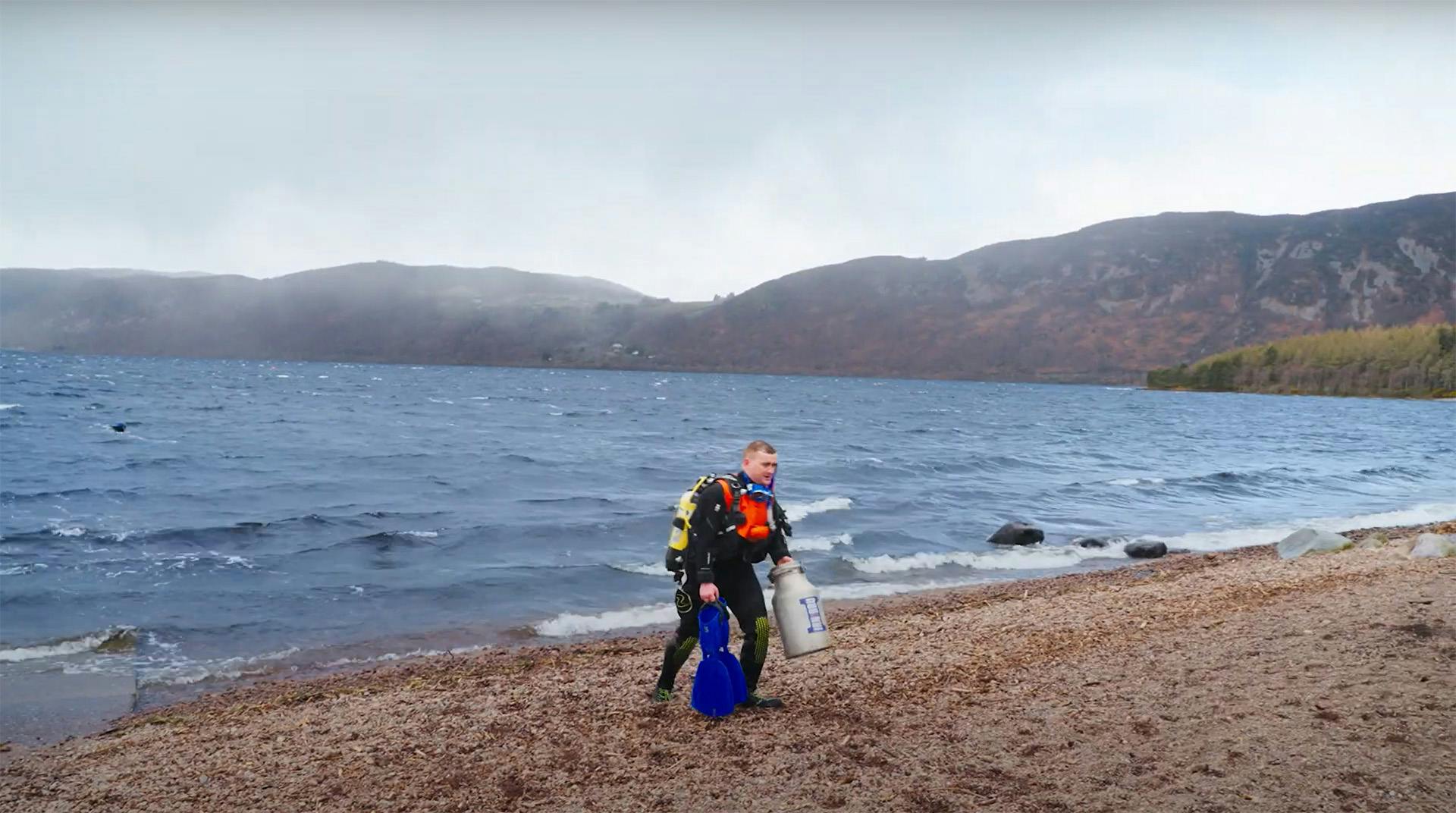Still from an Irn-Bru ad featuring a man in snorkelling gear walking out of a lake