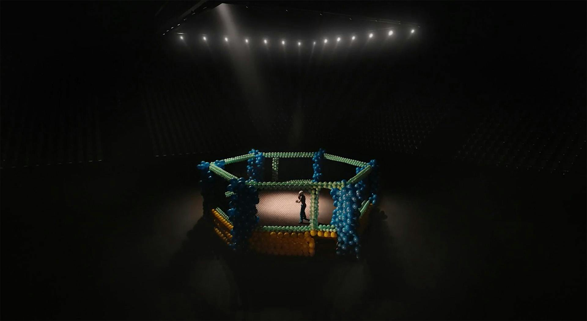 Still from a SickKids Foundation advert showing a young person in a boxing ring in the centre of a darkened room