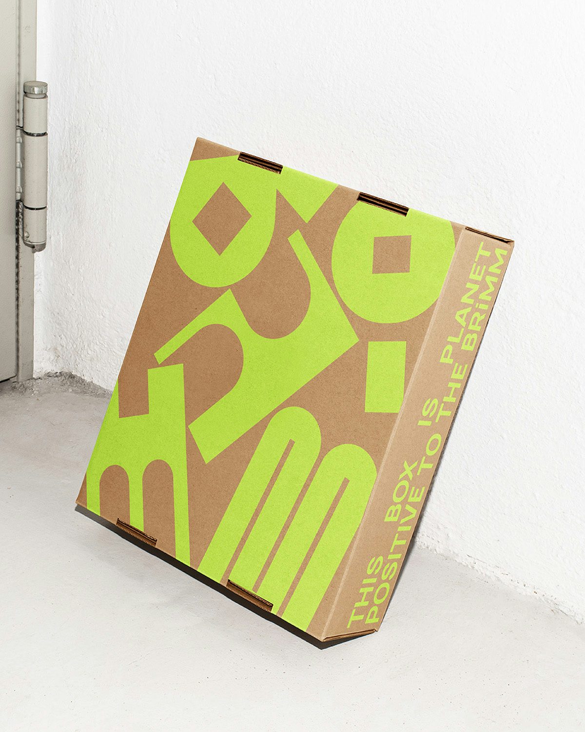 Brown box featuring the word 'BRiMM' in abstract lime green letters