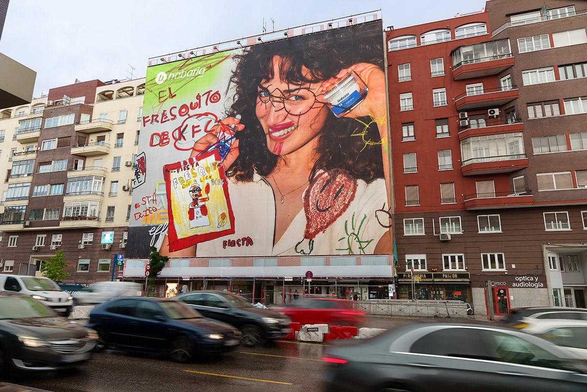KFC and Fiesta activation in a Madrid street featuring a billboard covered in childlike scribbles