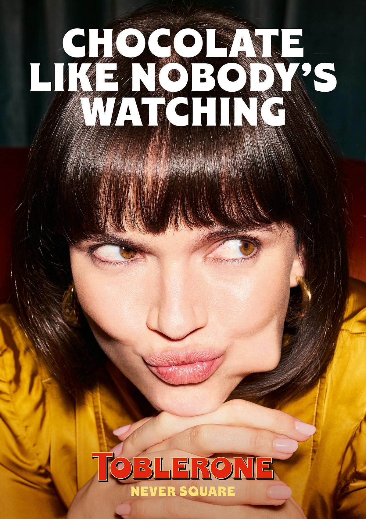 Image of a person eating Toblerone and the tagline 'Chocolate Like Nobody's Watching'