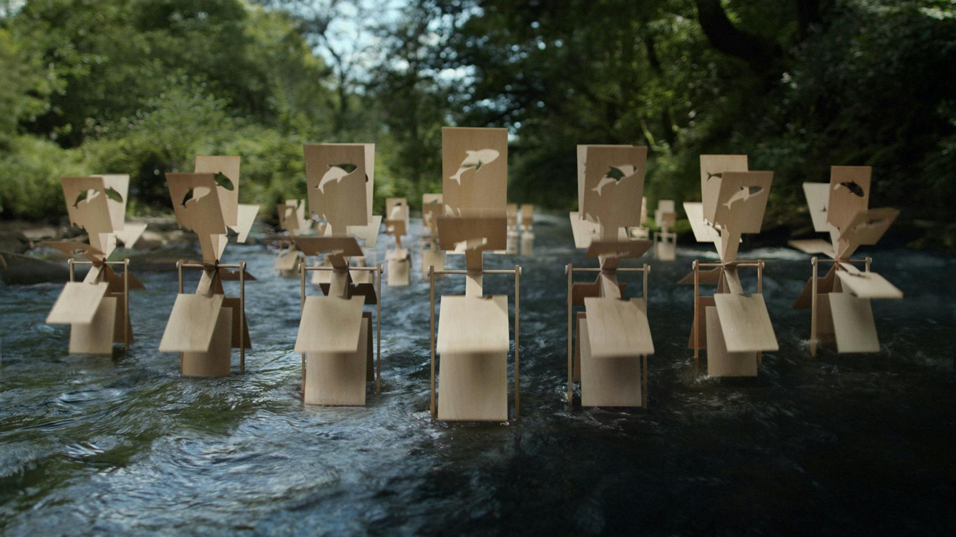 Wooden panels attached to wheels placed in a river
