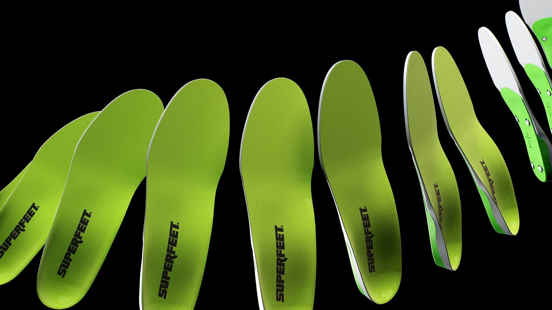 Row of bright green shoe soles featuring the Superfeet wordmark