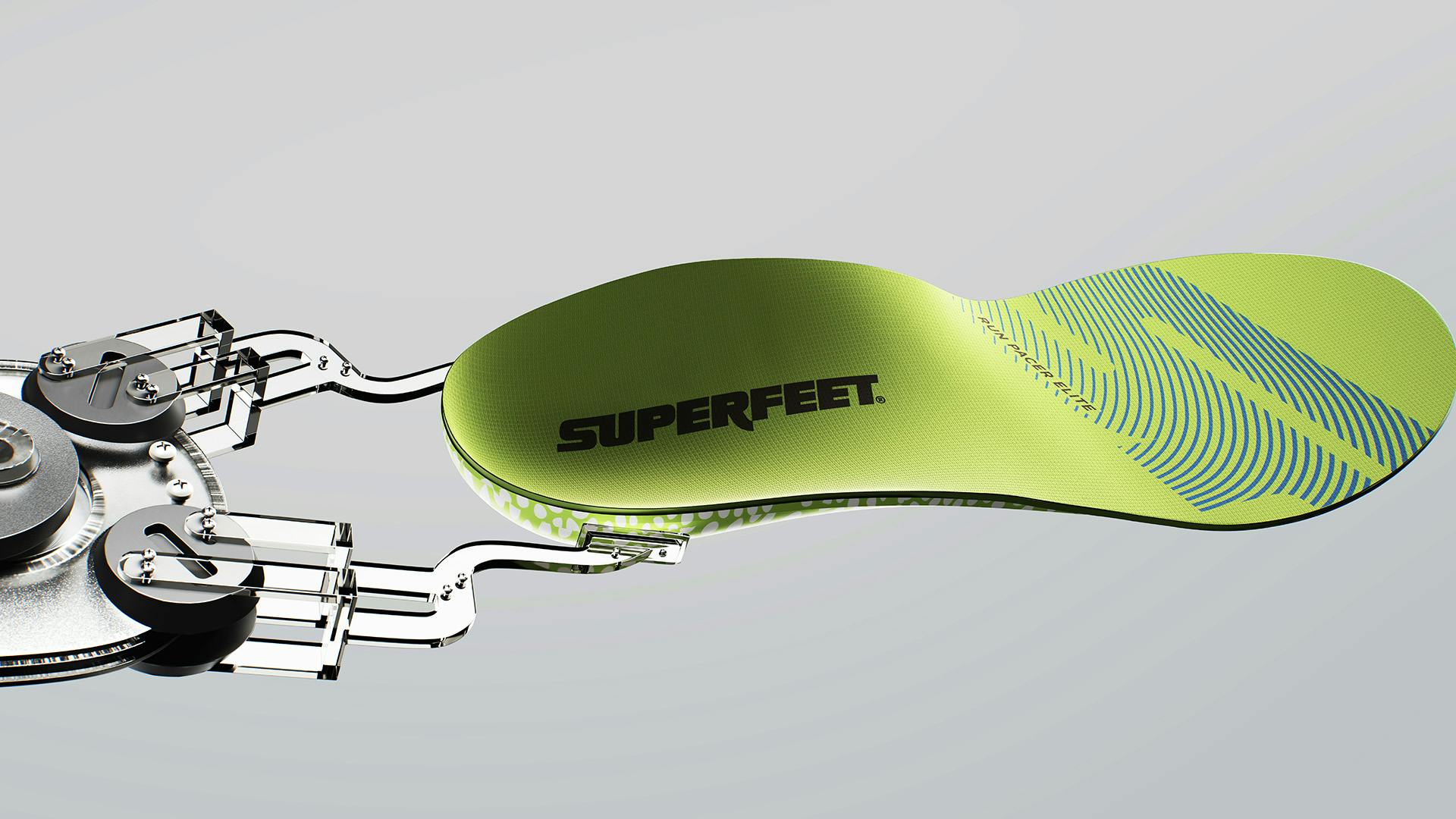 Green shoe sole featuring the Superfeet branding held up by a mechanical device