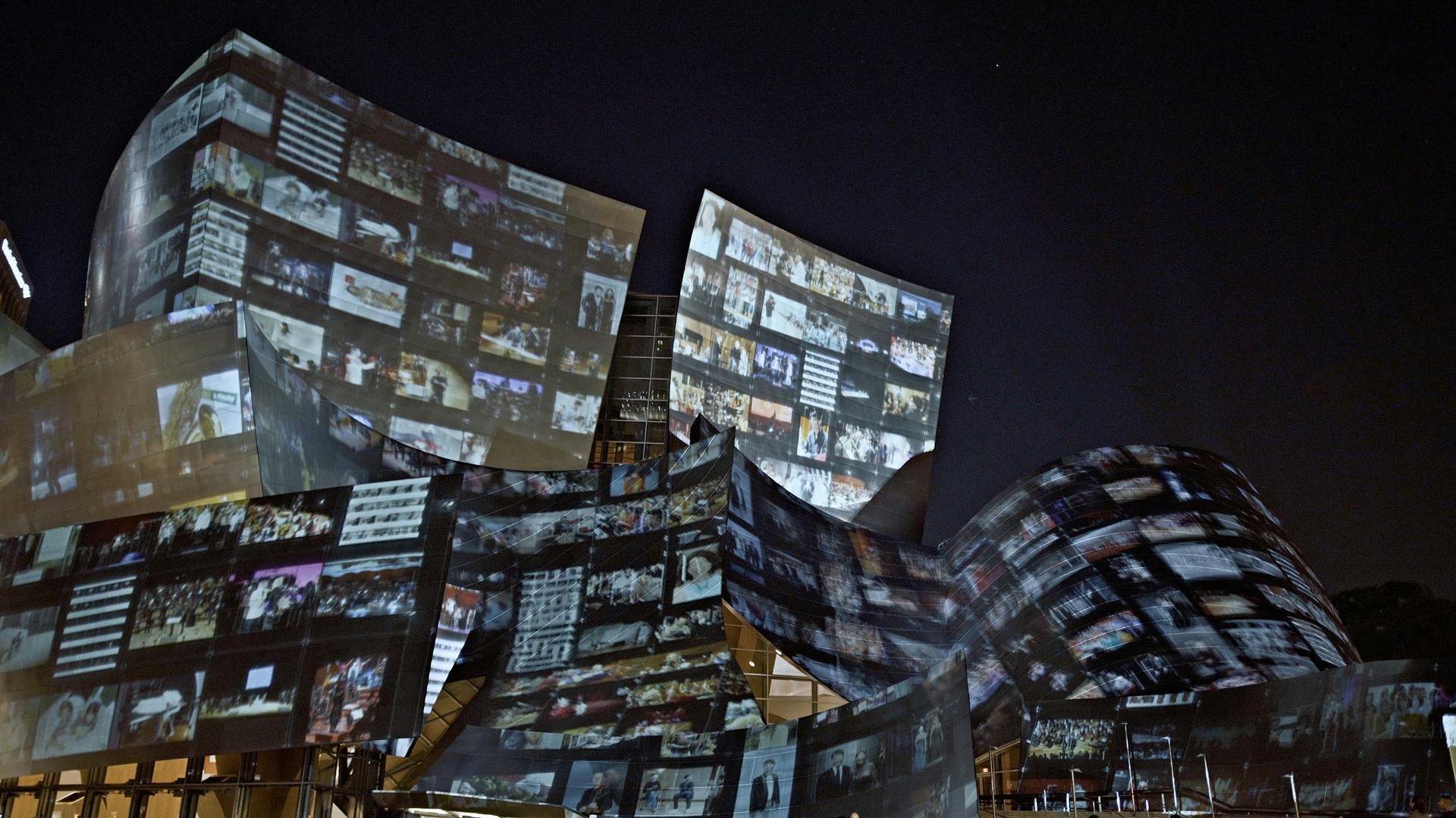 Image of the Walt Disney Concert Hall showing a projection by Refik Anadol on the exterior