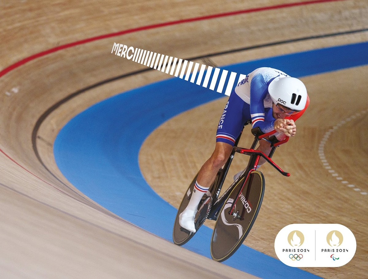 Poster of a cyclist on an indoor track alongside the word 'merci'