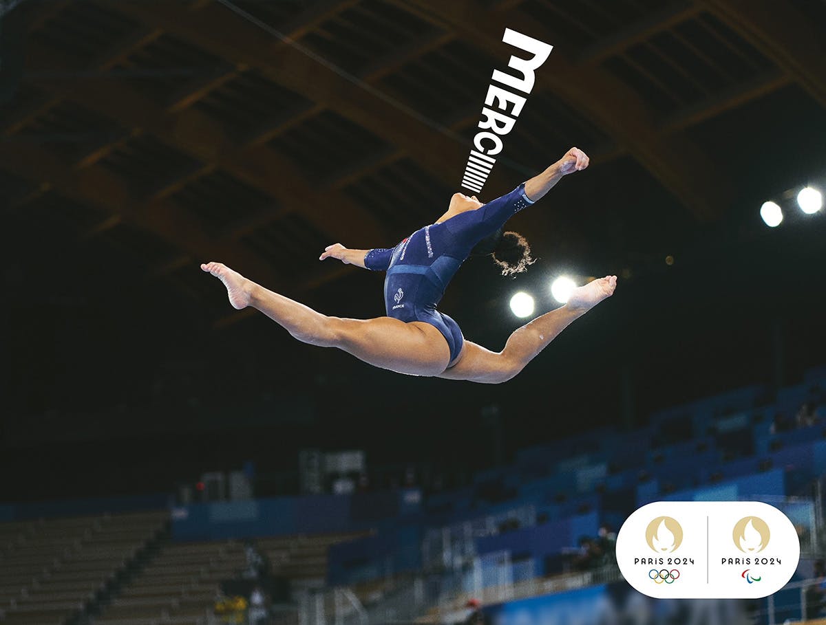 Poster of a gymnast jumping in the air with the word 'merci' appearing to protude from her mouth
