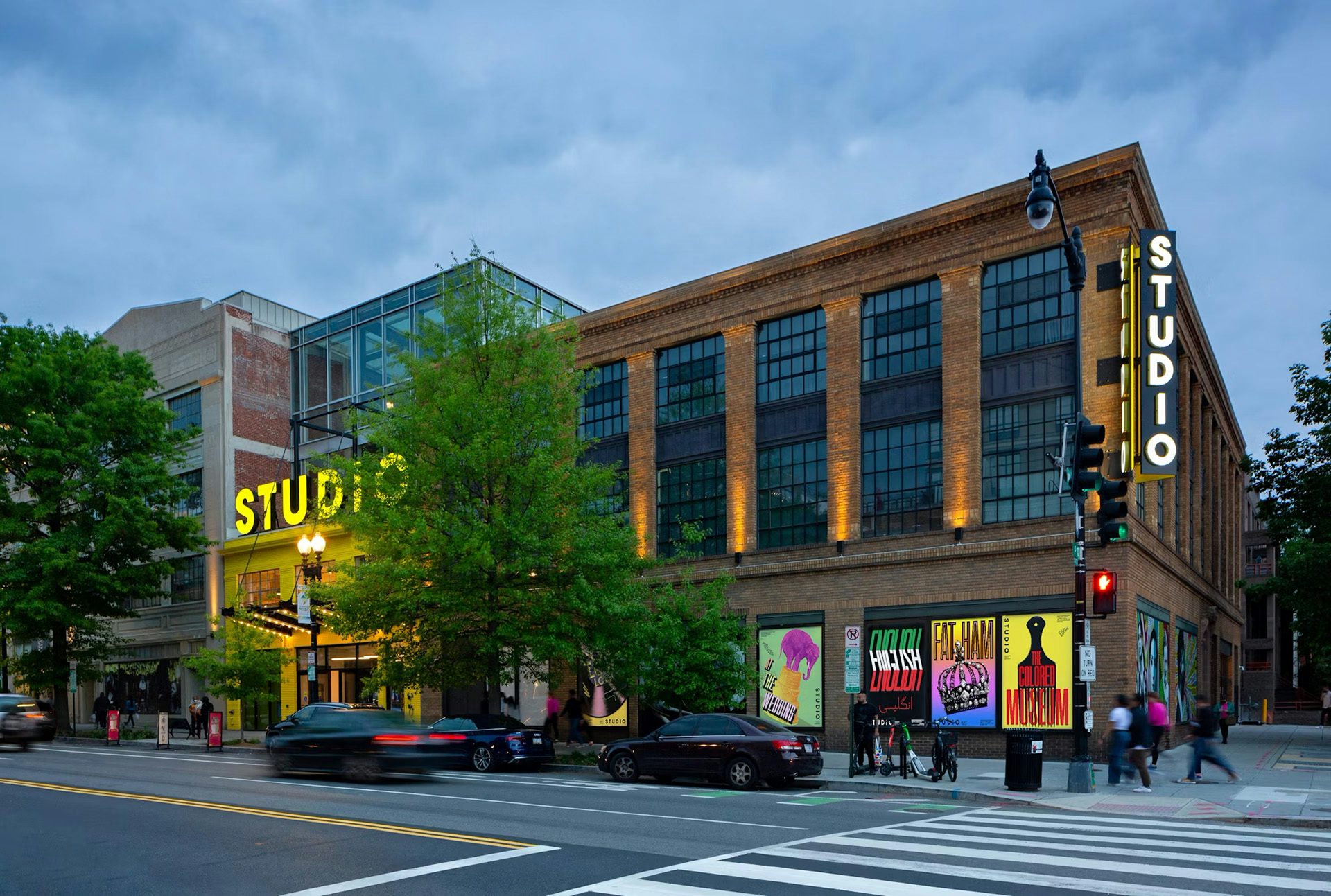 Exterior of Studio Theatre at dusk showing its new promotional posters