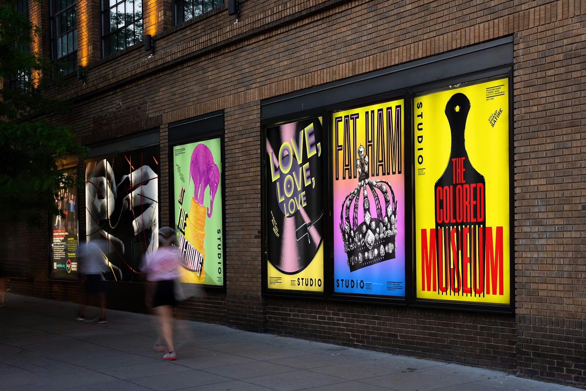 Exterior of Studio Theatre showing a row of promotional posters lining the wall