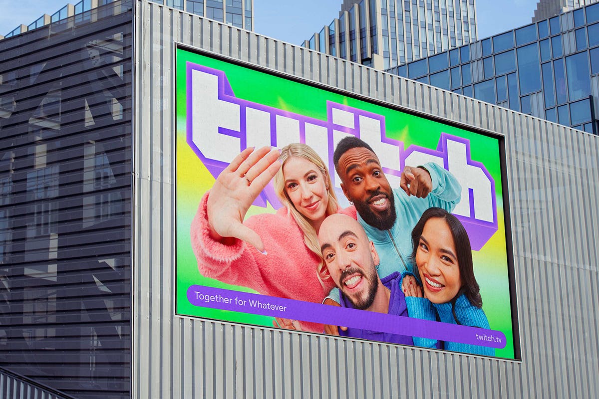 Outdoor advert for Twitch featuring the brand's geometric retro wordmark and portraits of smiling people shot against a green and yellow background