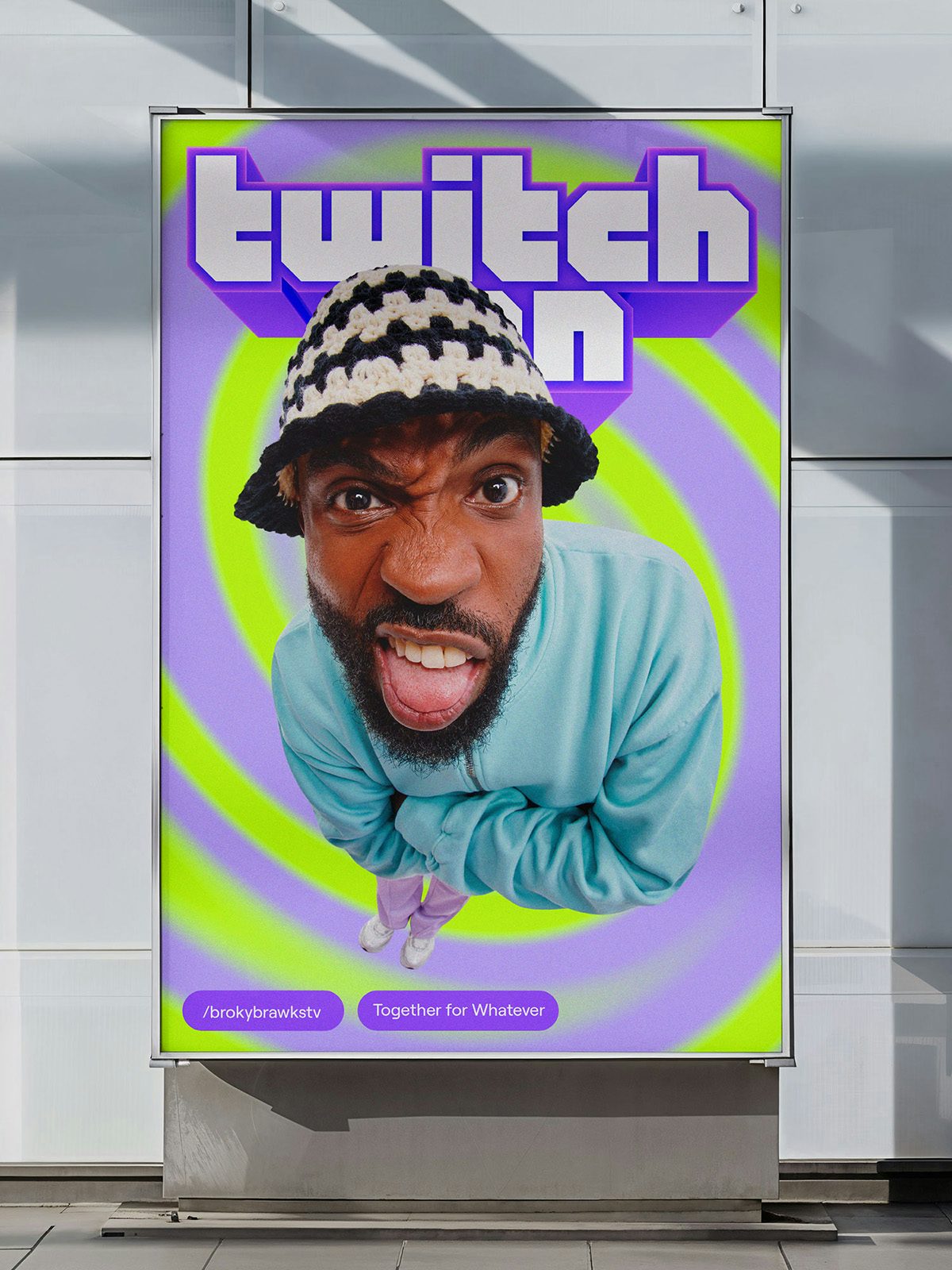 Outdoor advert for Twitch featuring the brand's retro geometric wordmark and a portrait of a person wearing a bucket hat and sticking their tongue out, against a purple and green swirling background