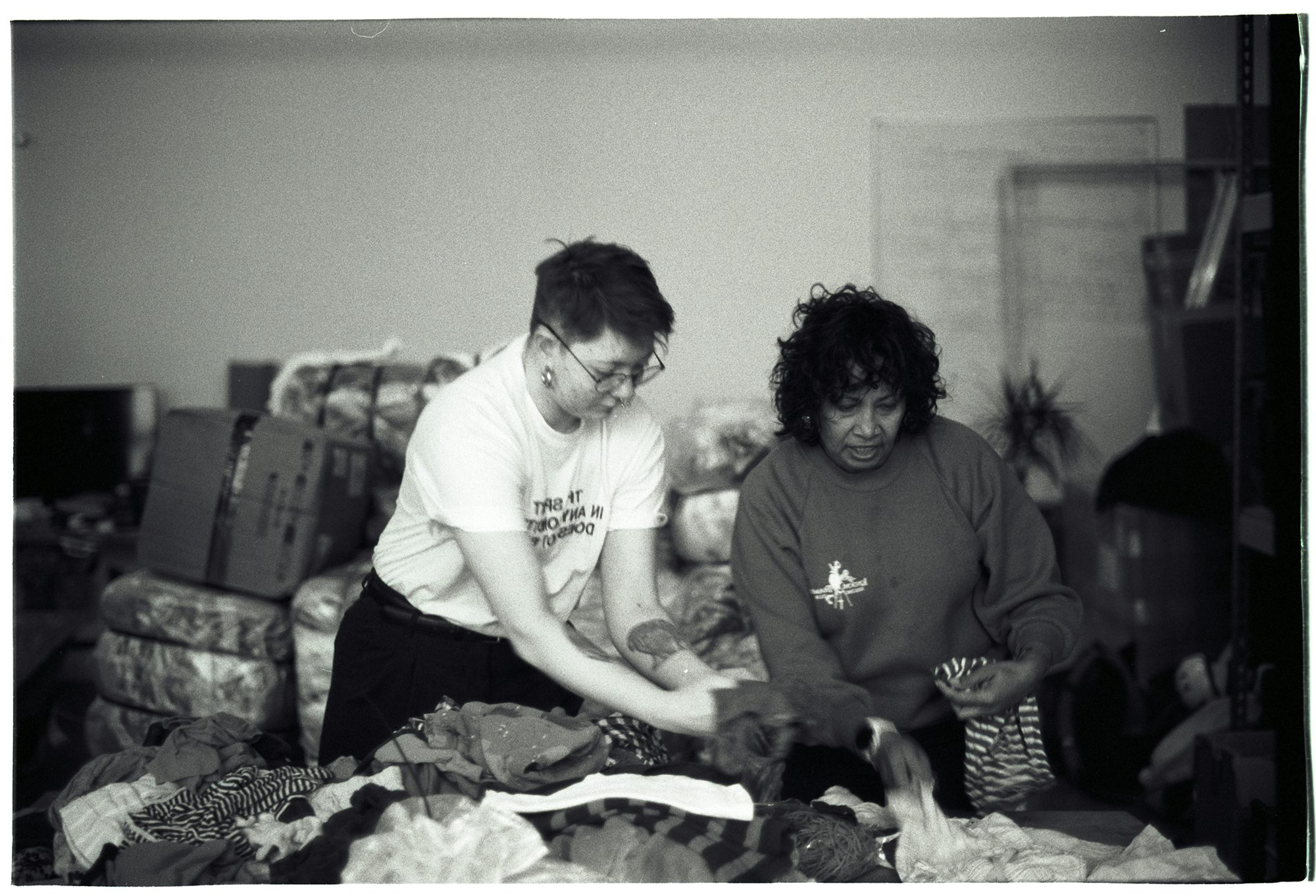 Two women sort children's clothing