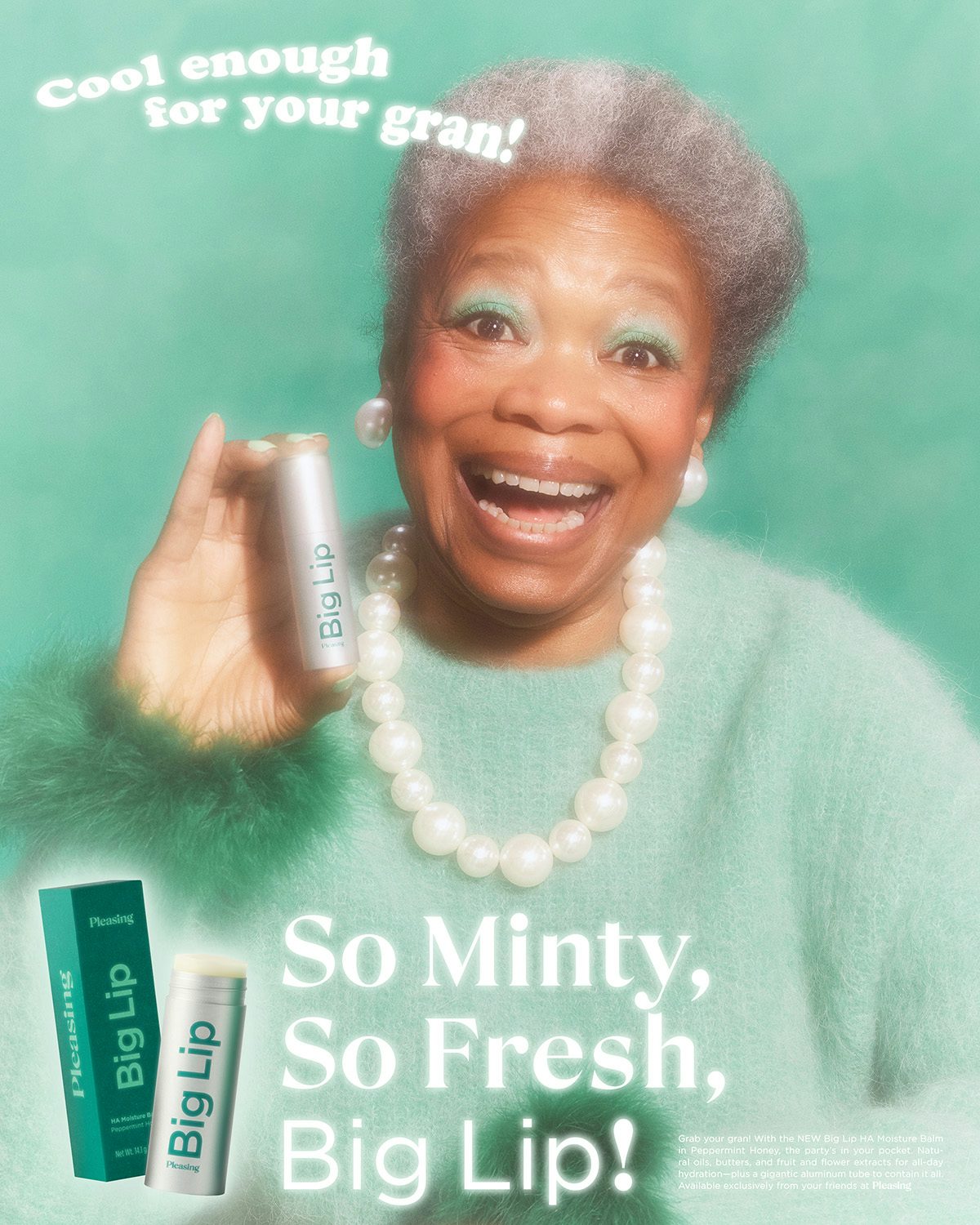 Photo by Jakub Gessler of a smiling woman with short grey hair, a pearl necklace and mint coloured jumper holding a tube of lipstick up to the camera. The tagline is 'so minty, so fresh, big lip'