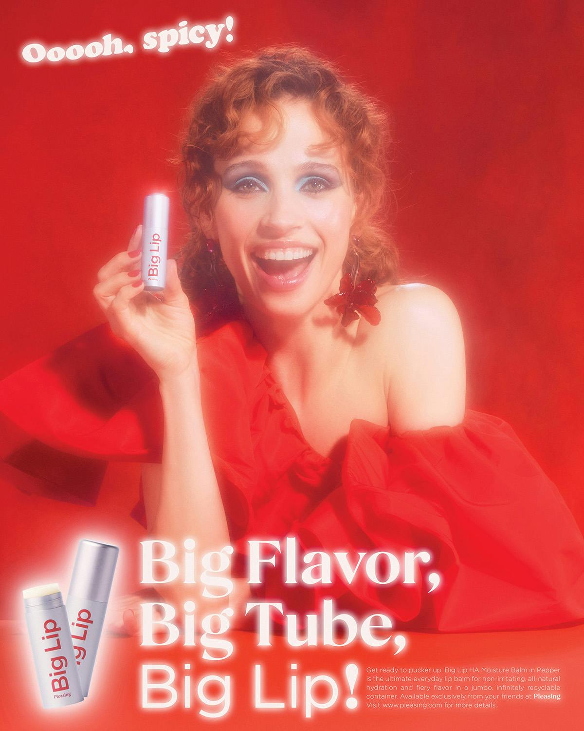 Photo by Jakub Gessler of a woman with ringlets and wearing a red sleeveless puffy dress while holding up liptstick to the camera against a red backdrop