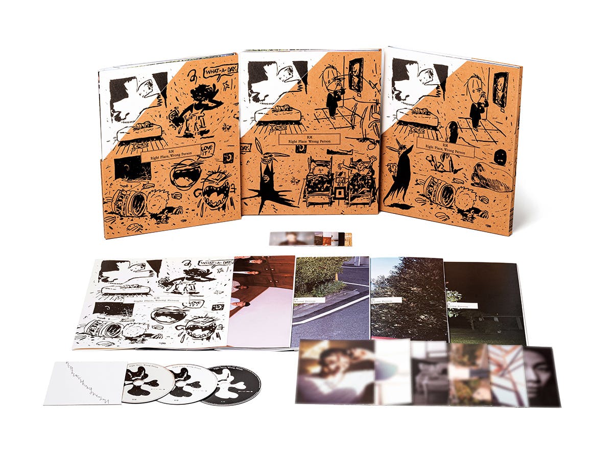 Album materials for Right Place Wrong Person by RM featuring illustrated booklets and photo zines