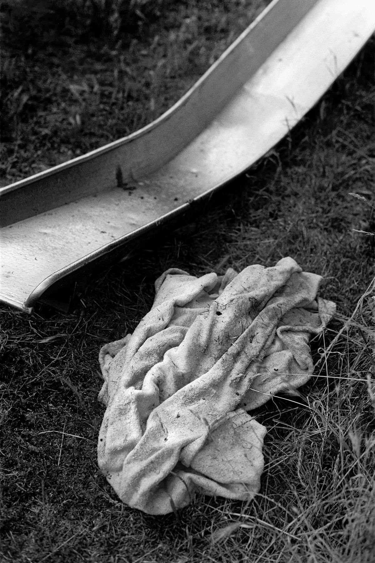Black and white photo of a slide with a dressing gown in a pile next to it
