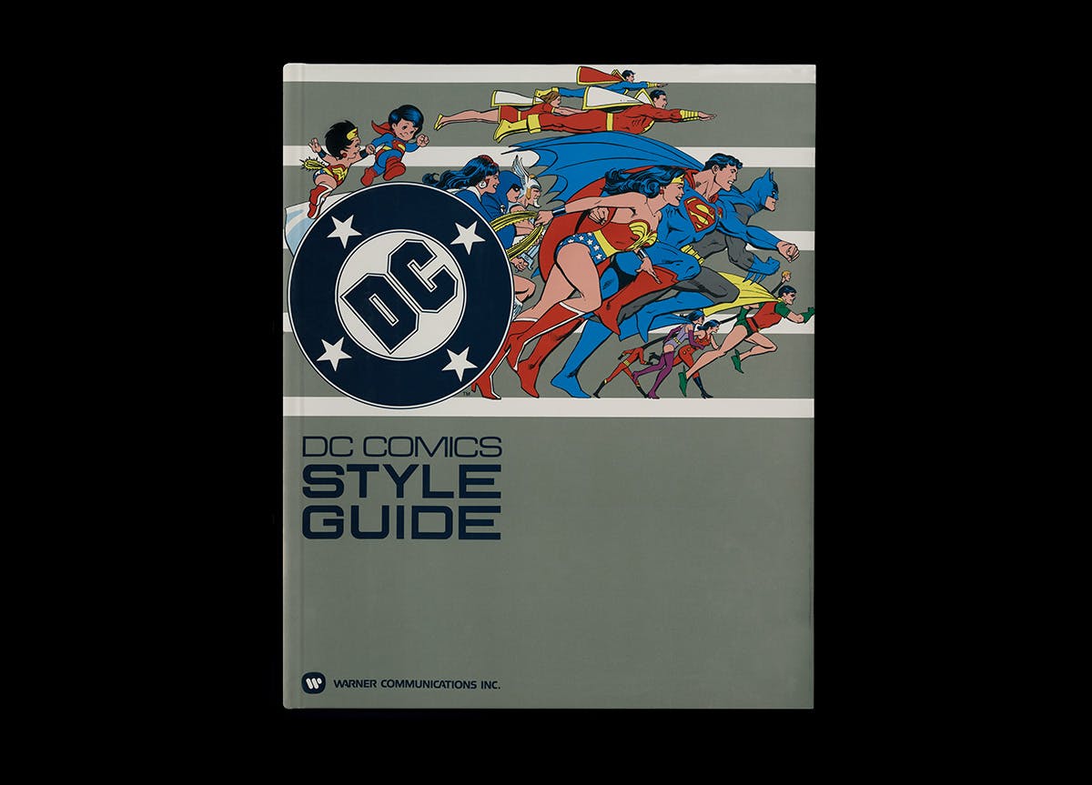 Cover of DC Comics style guide featuring illustrations of Superman, Catwoman, Batman and others appearing to run across the page