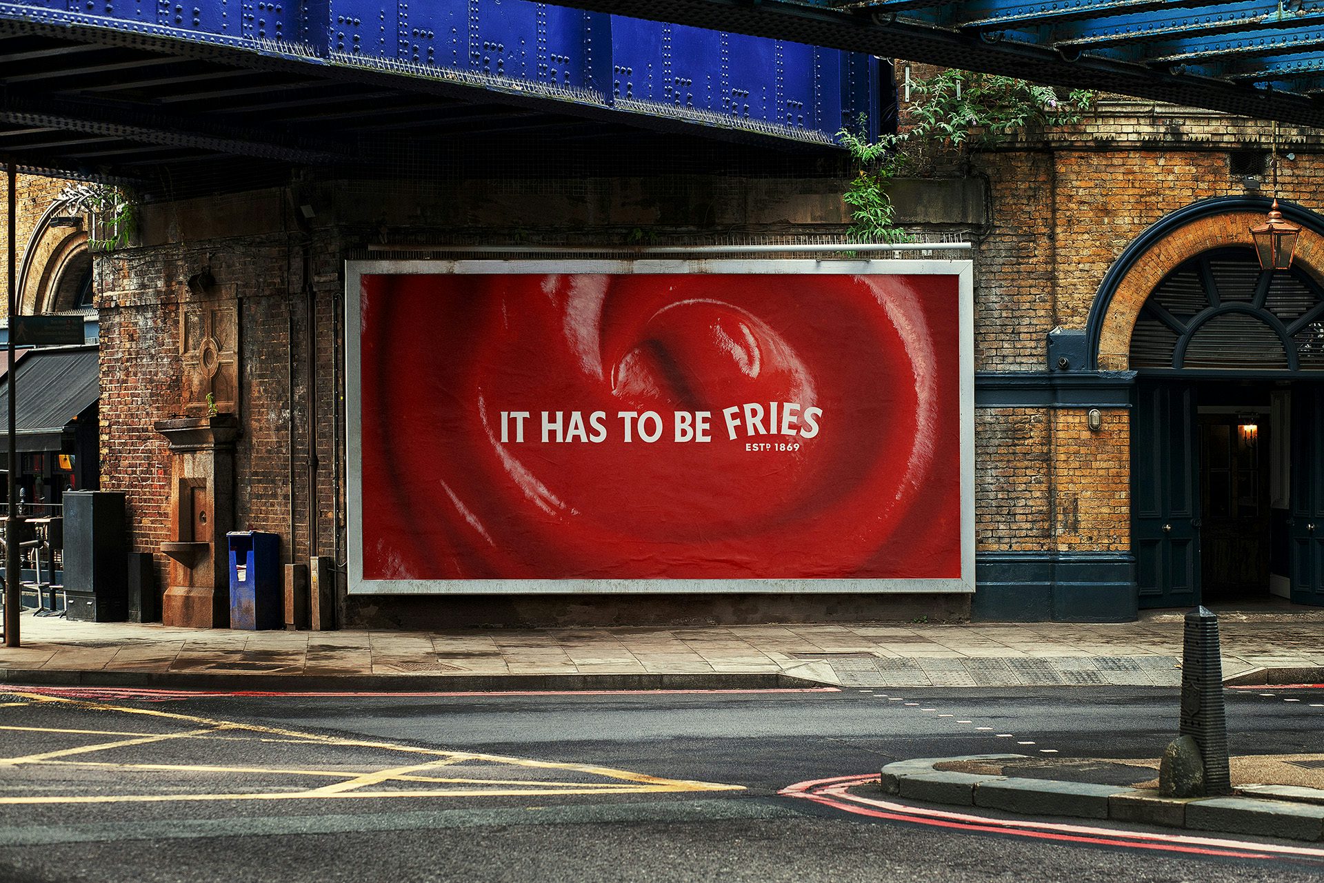 Outdoor ad featuring a close up image of ketchup overlaid with the endline 'it has to be fries' with the word 'Fries' arched in the style of the Heinz logo