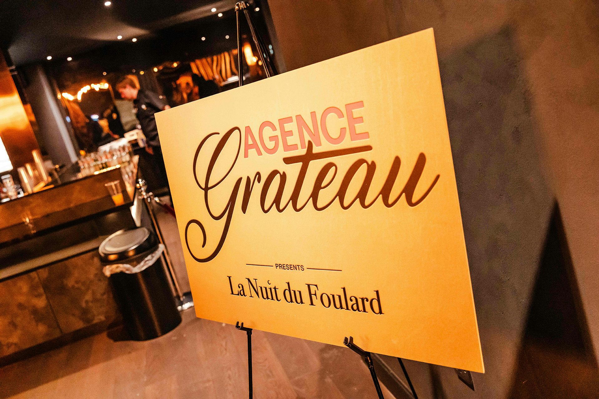 A sign that reads 'Agence Grateau' at an Emily in Paris event by Studio Secret Cinema