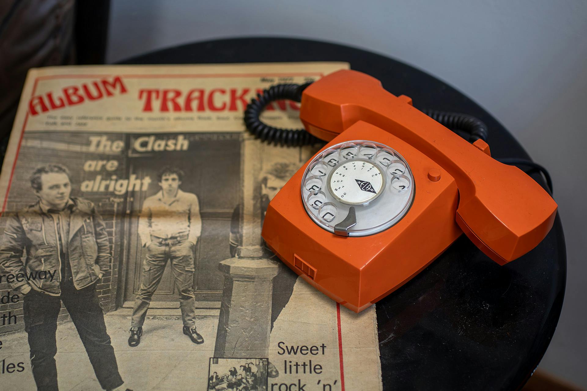 Orange telephone and The Clash newspaper feature from the Rock & Roll Public Library