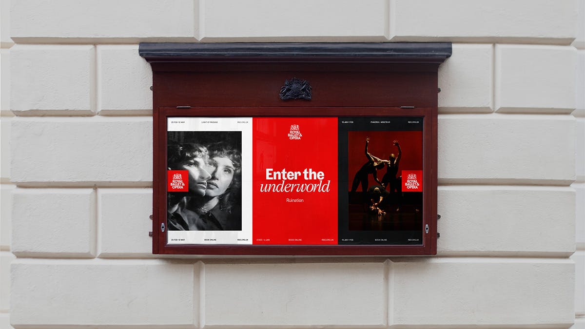 Display case outside a building showing red, white and black Royal Ballet and Opera posters headlined 'enter the underworld' and featuring abstract photographs of people