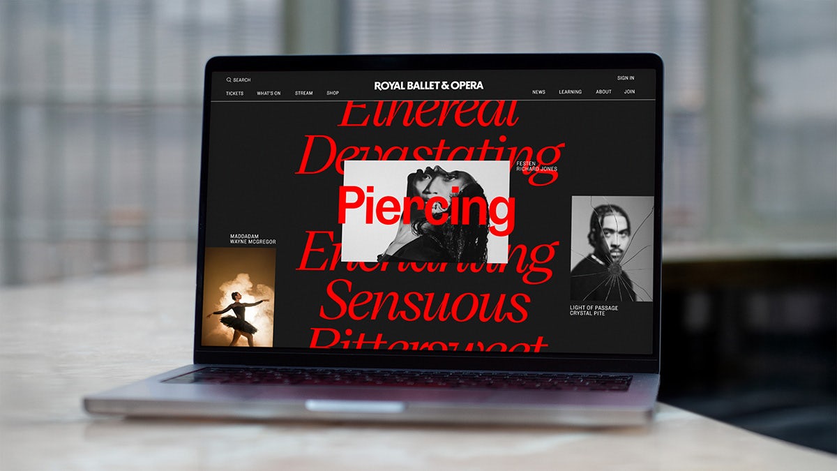 Laptop showing the Royal Ballet and Opera website which reads 'ethereal, devastating, piercing, sensuous' over the top of austere images of people's faces