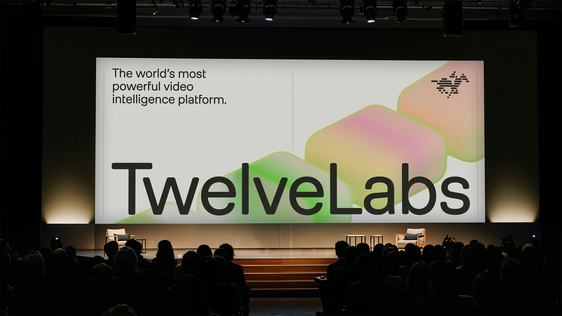 Large screen featuring the brand name TwelveLabs over a soft gradient background in an auditorium