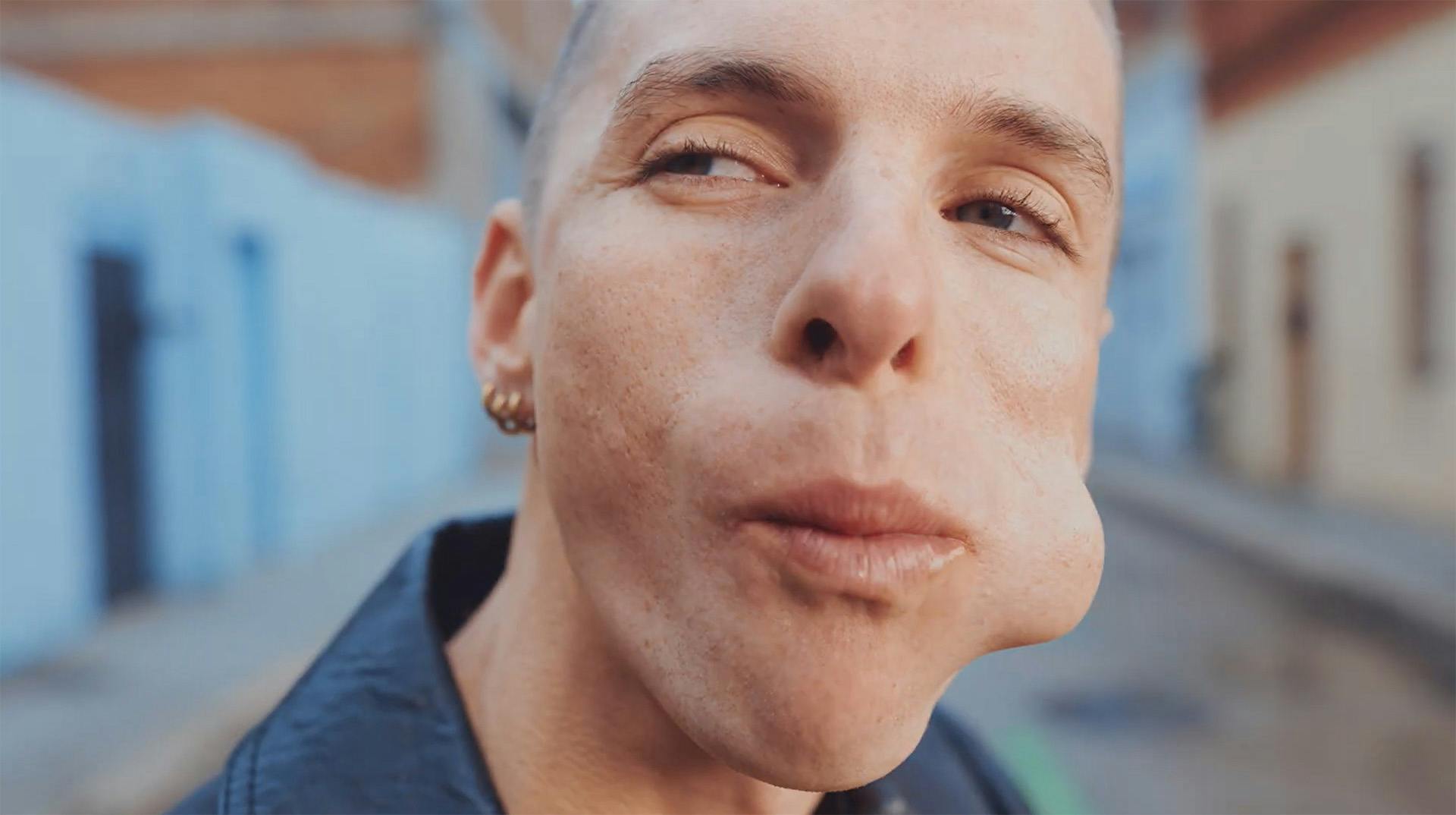 Still from Toblerone ad showing a close-up of a person eating Toblerone causing their cheek to bulge