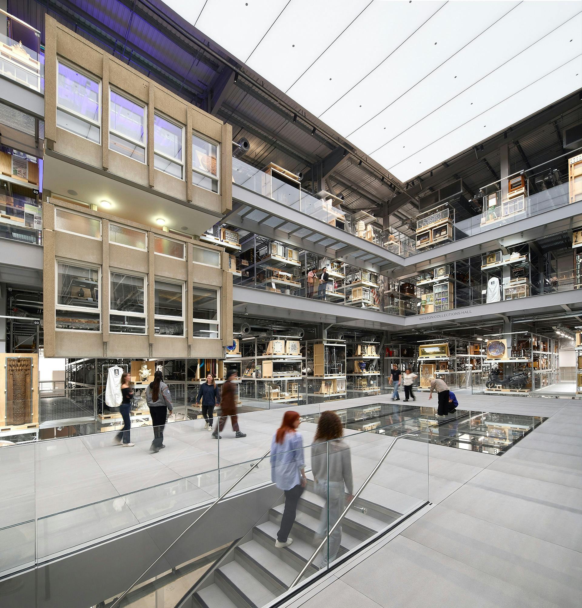 Inside the V&A East Storehouse featuring a main floor with a partial glass section and multiple levels surrounding it on all sides