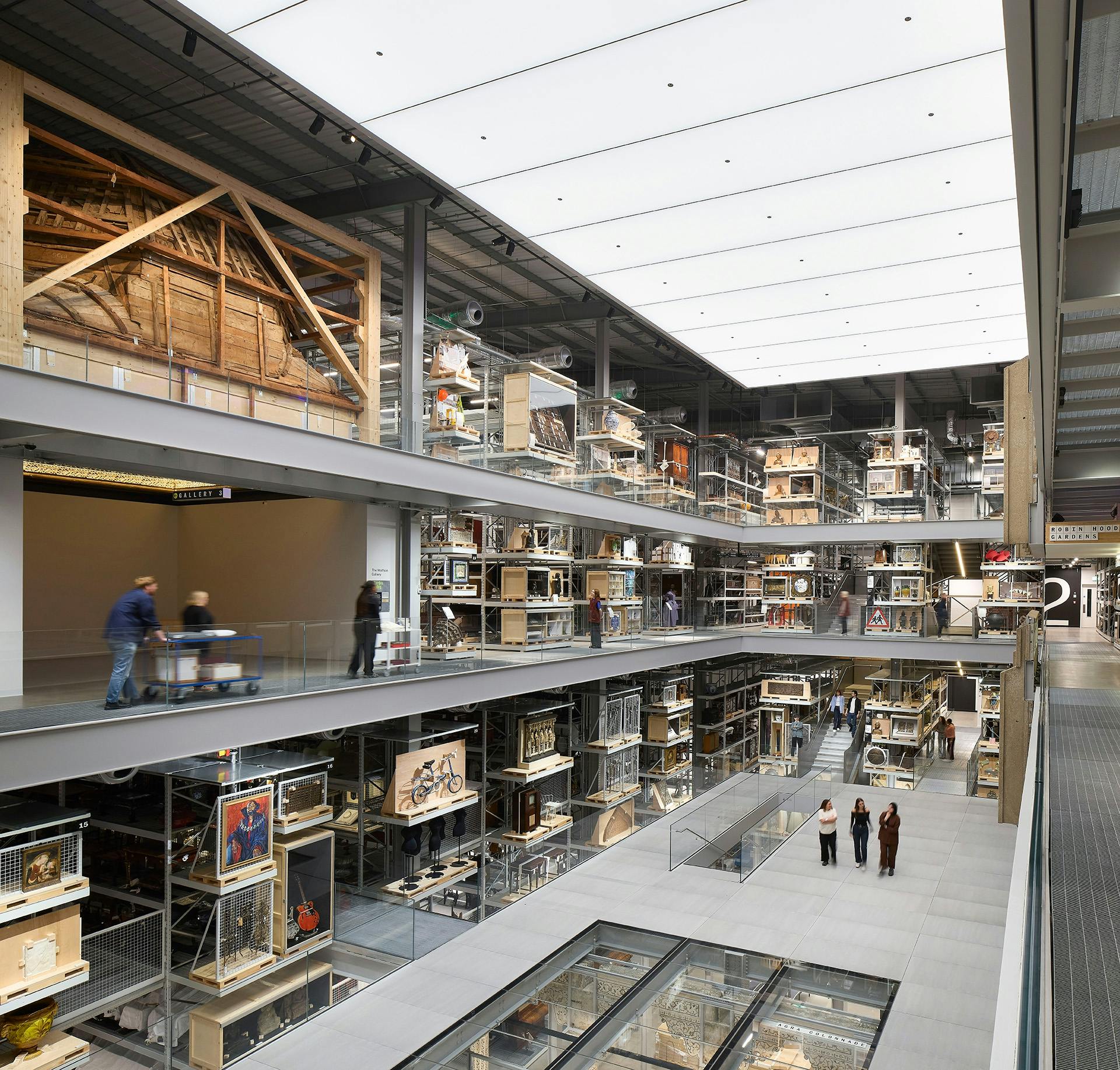 Inside the V&A East Storehouse featuring a main floor with a partial glass section and multiple levels surrounding it on all sides