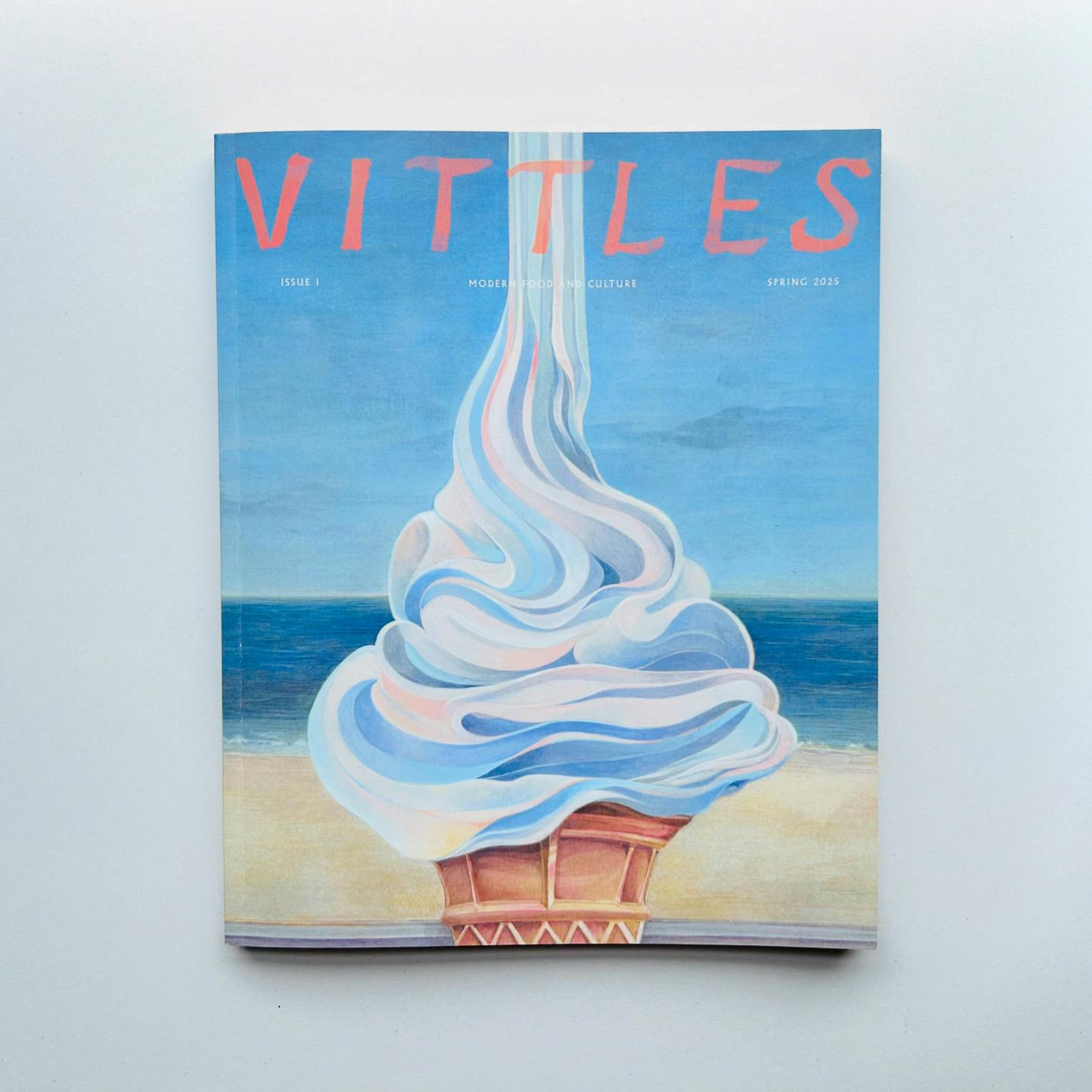 Cover of Vittles magazine issue one featuring an illustration of an soft serve ice cream pouring from above with a beachfront in the background