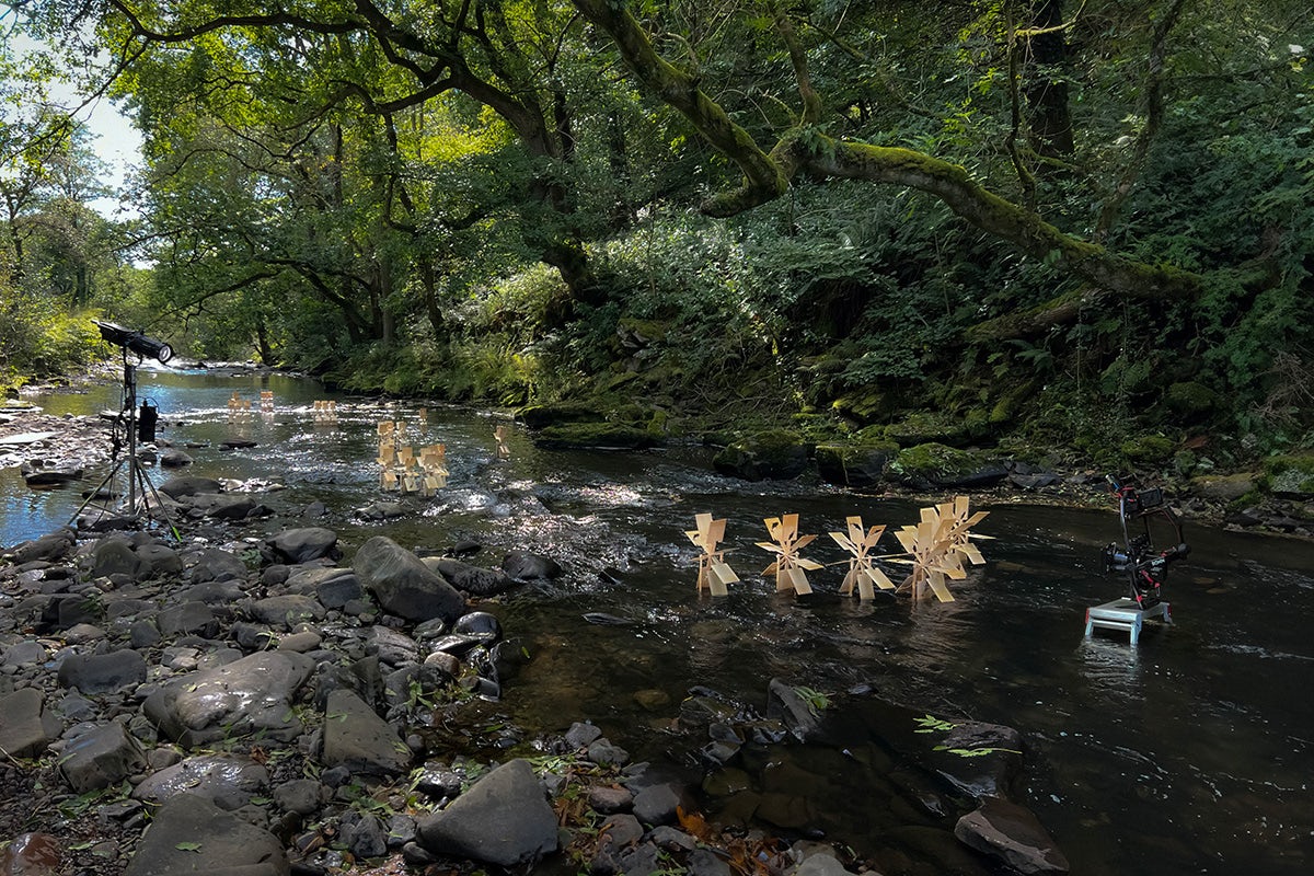 Wooden panels attached to wheels placed in a river