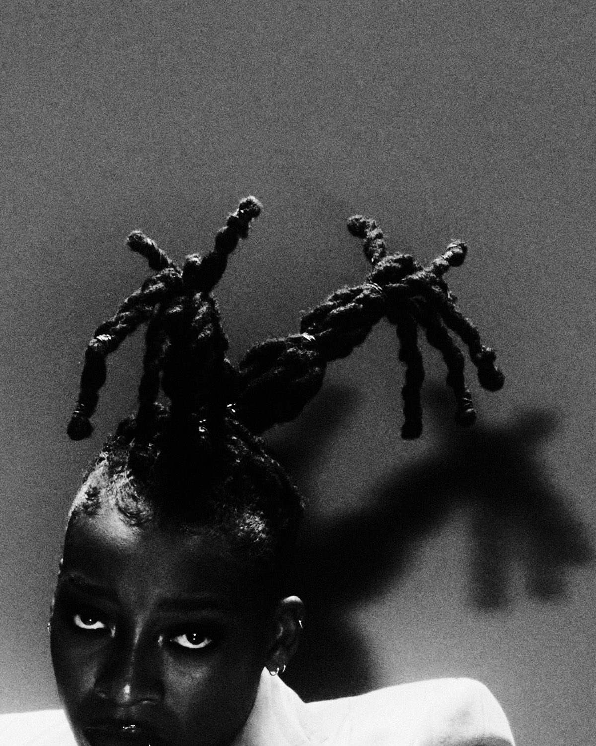 Cut-off black and white portrait of Little Simz by Thibaut Grevet