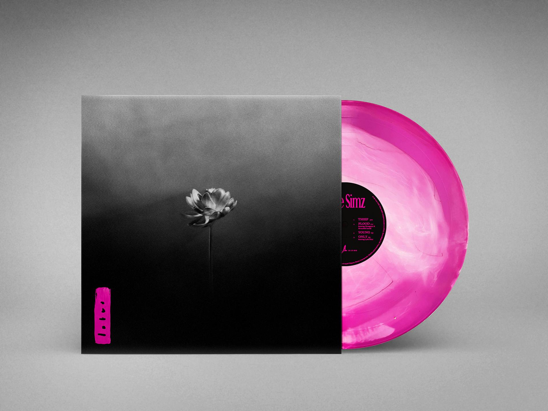 Record design for Lotus by Little Simz featuring a black and white image of a lotus flower on the cover and a bright pink vinyl record