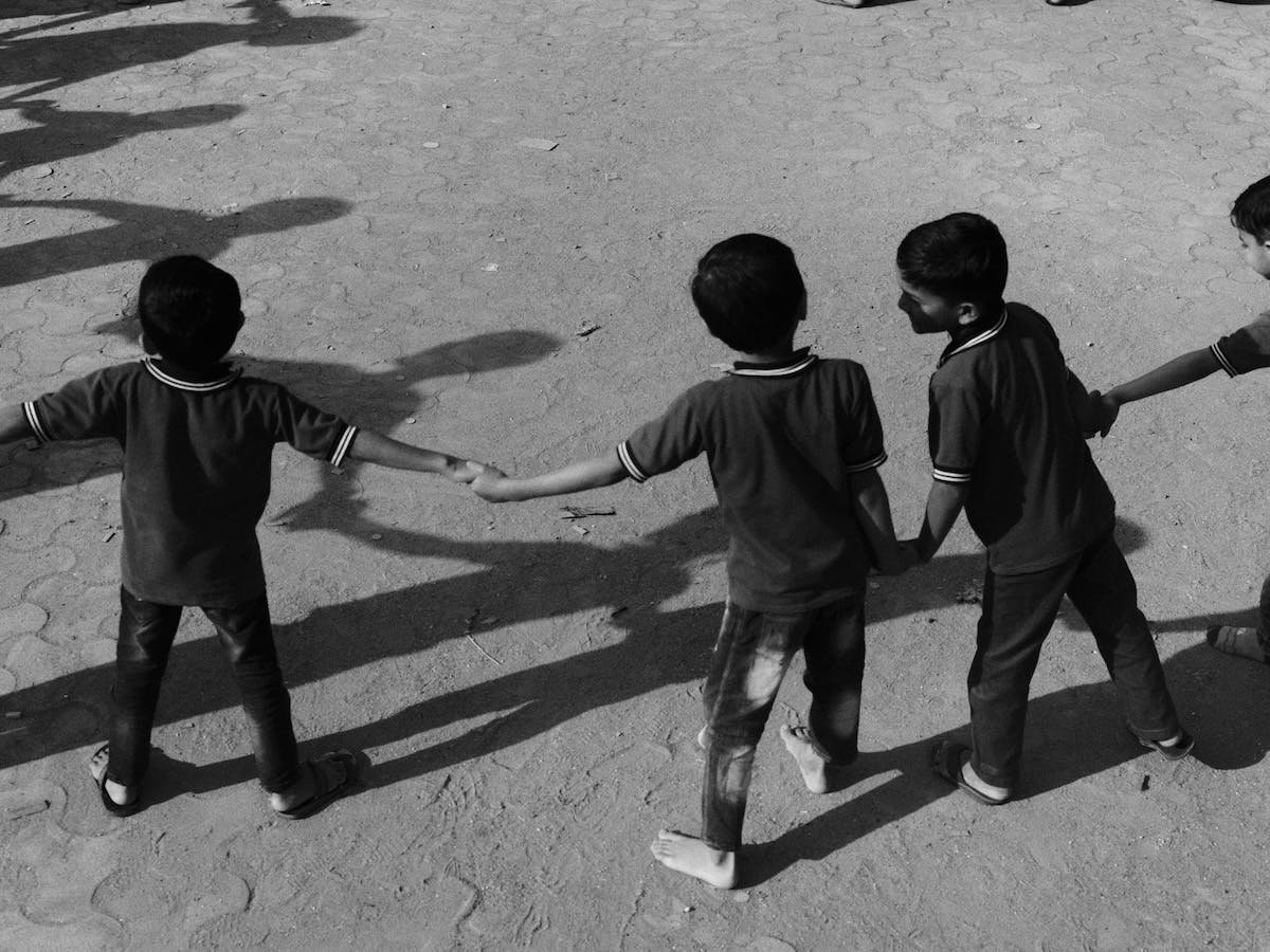 Black and white photo by Vivek Vadoliya of a group of children holding hands