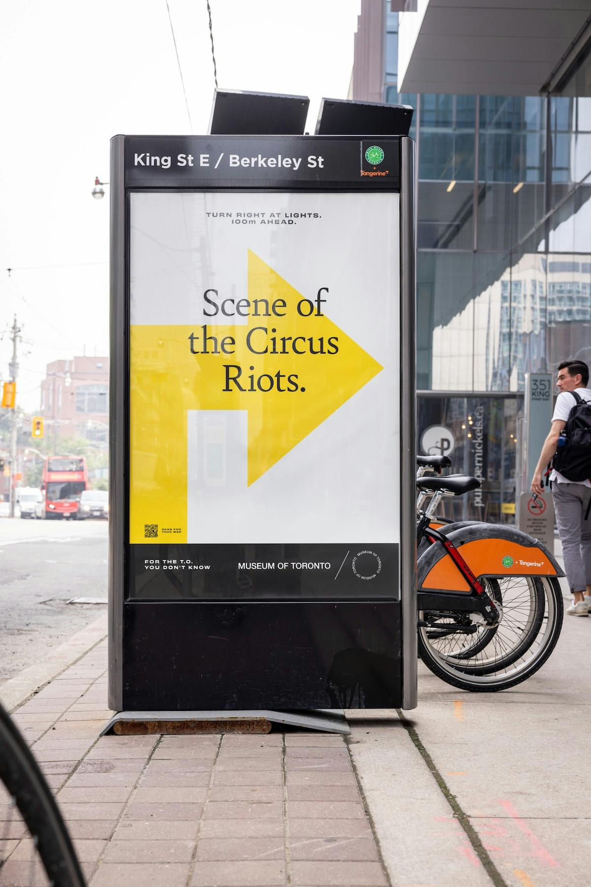 Museum of Toronto outdoor ad that reads 'scene of the circus riots' with an arrow in the background
