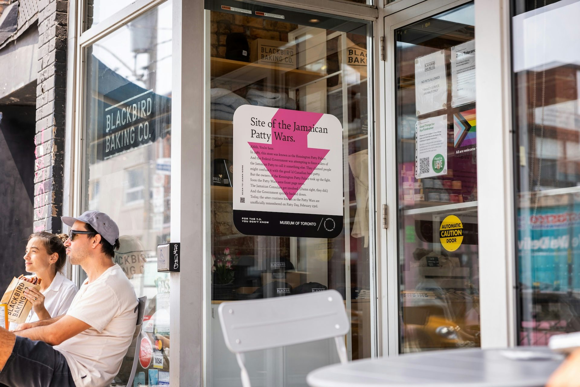 Museum of Toronto outdoor ad featuring an arrow and a headline that reads 'Site of the Jamaican patty wars'